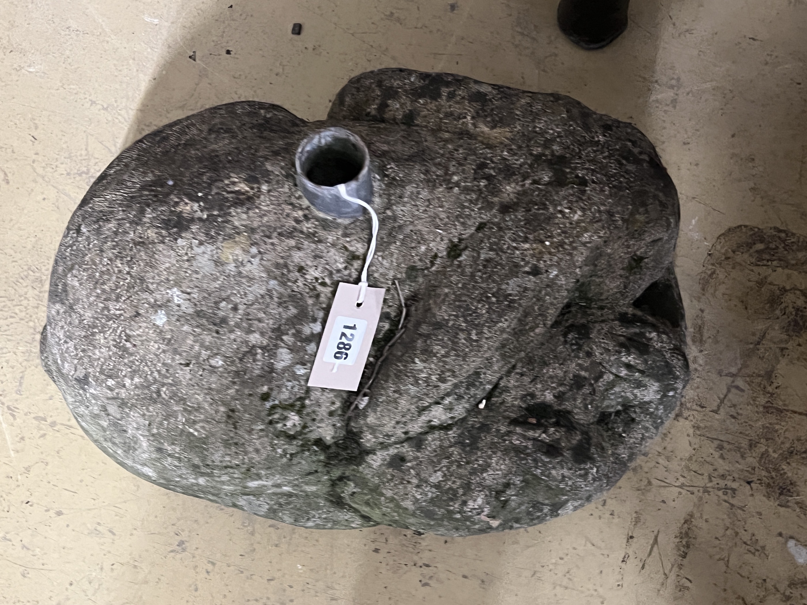 A reconstituted stone rabbit garden ornament, possibly a parasol base, width 48cm, height 30cm